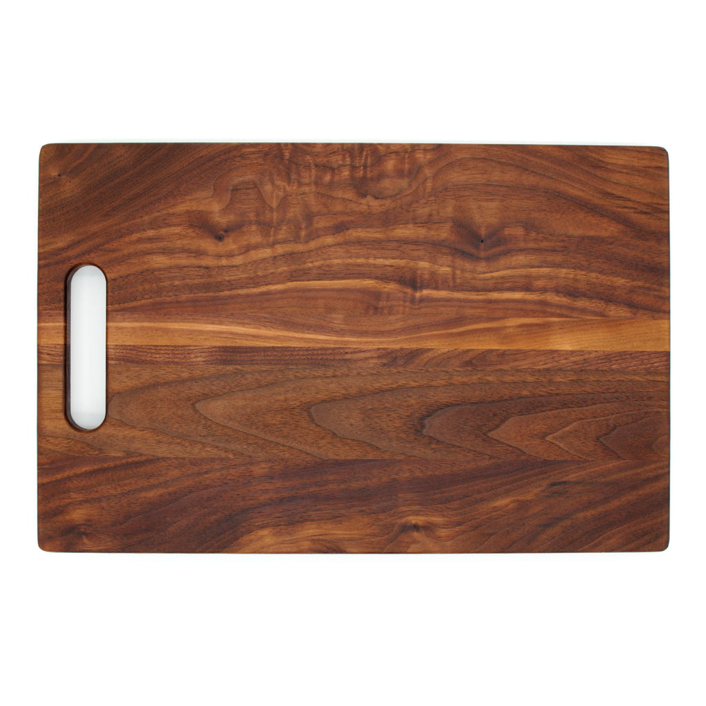 Walnut single handle cutting board, 16 x 10.5 in, overhead view showing swirling dark grain