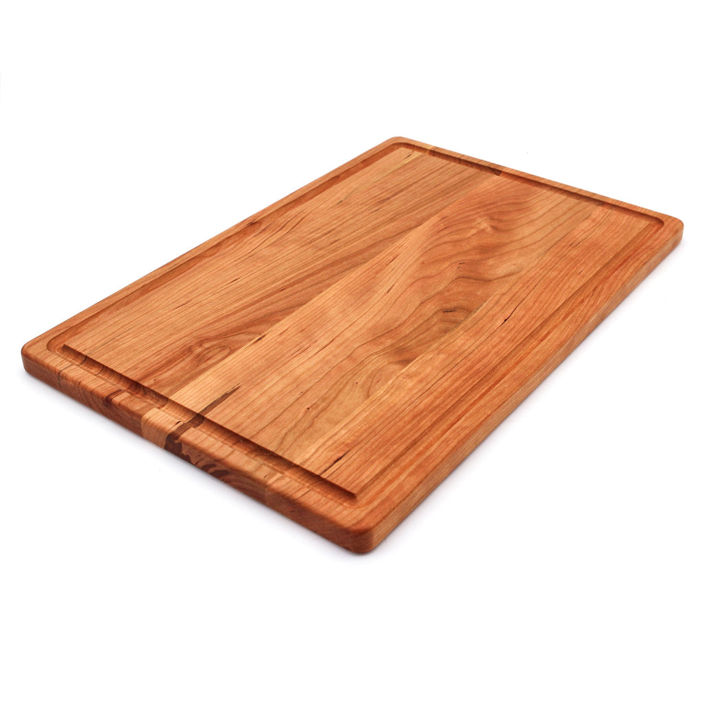 Cherry cutting board with a juice groove, 18 x 12 in, angled view on white showing the thin edge