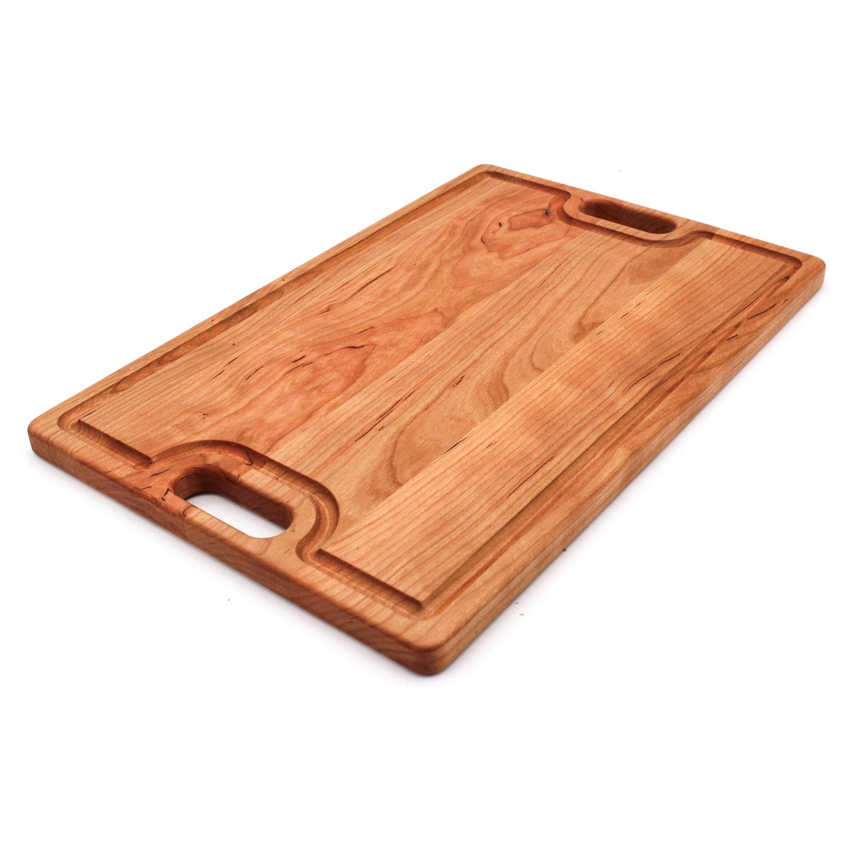 Cherry cutting board with a juice groove and cutout handle, 18 x 12 in, angled view on white