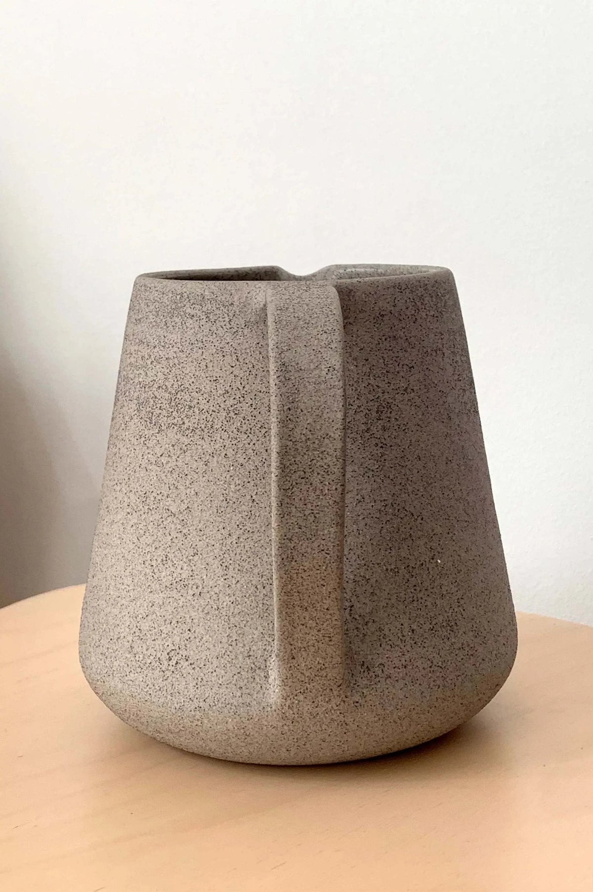 Concrete-Toned Stoneware Pitcher styled on a wood table with linen in a modern Southwest room