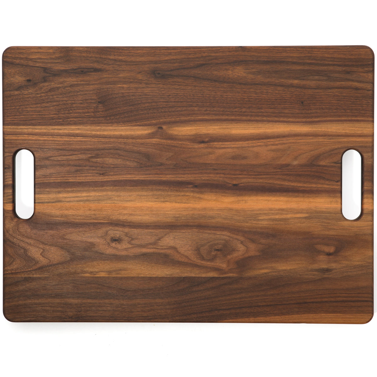 Extra large walnut cutting board with cutout handles, 24 x 18 in, overhead view of the plain face on white