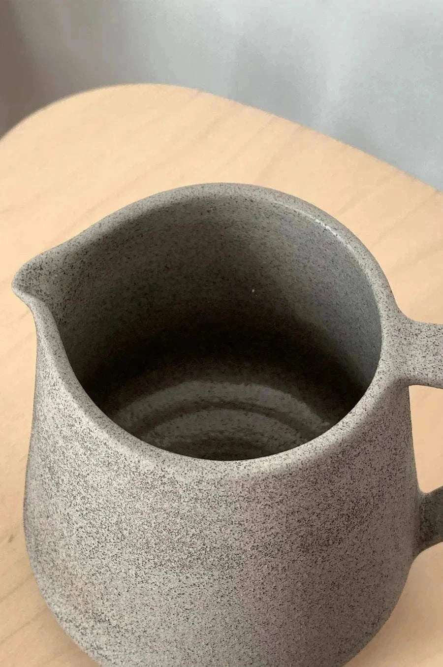 Concrete-Toned Stoneware Pitcher pictured from a higher angle showing shape and proportions