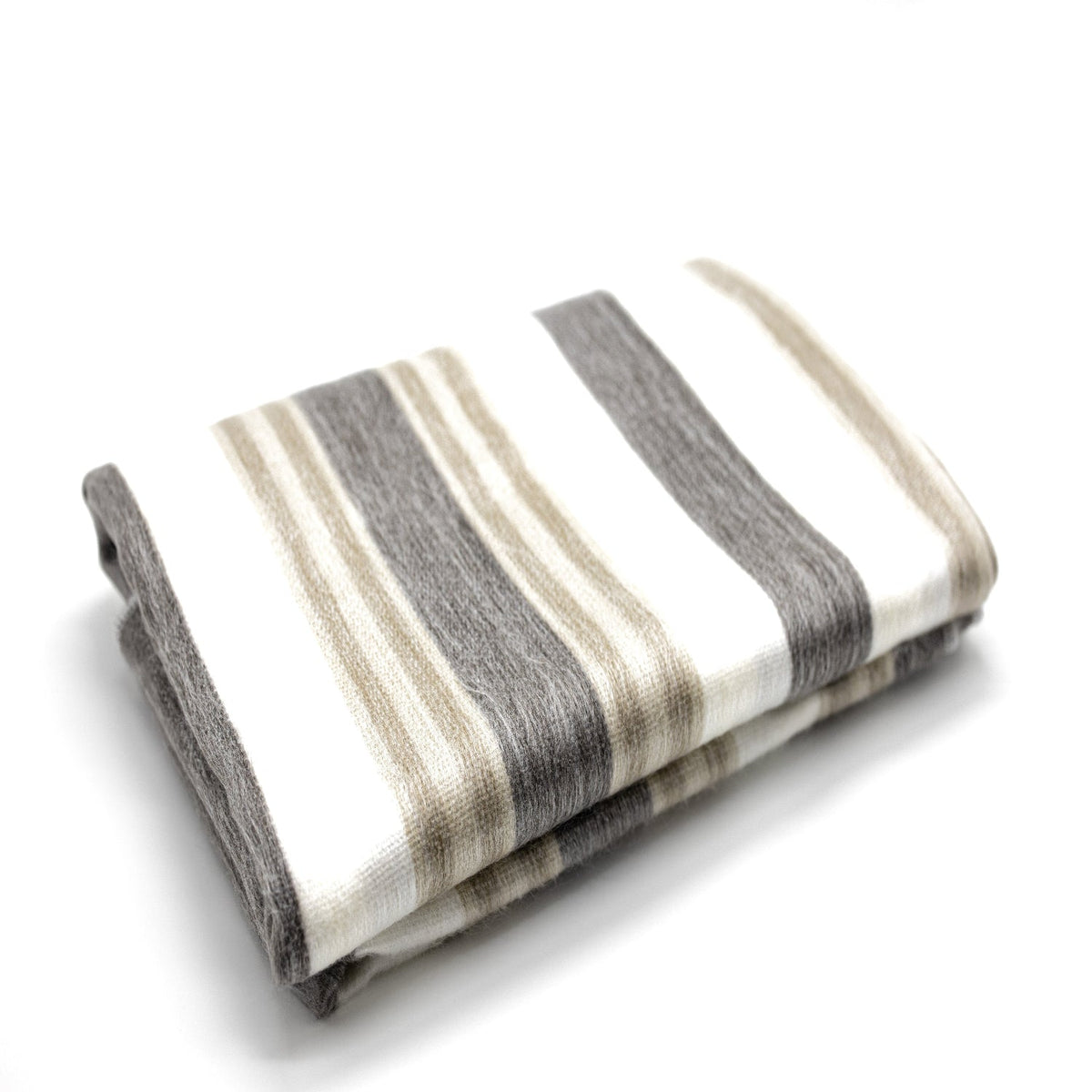 Neatly folded handwoven alpaca throw in cream and charcoal stripes on a white background