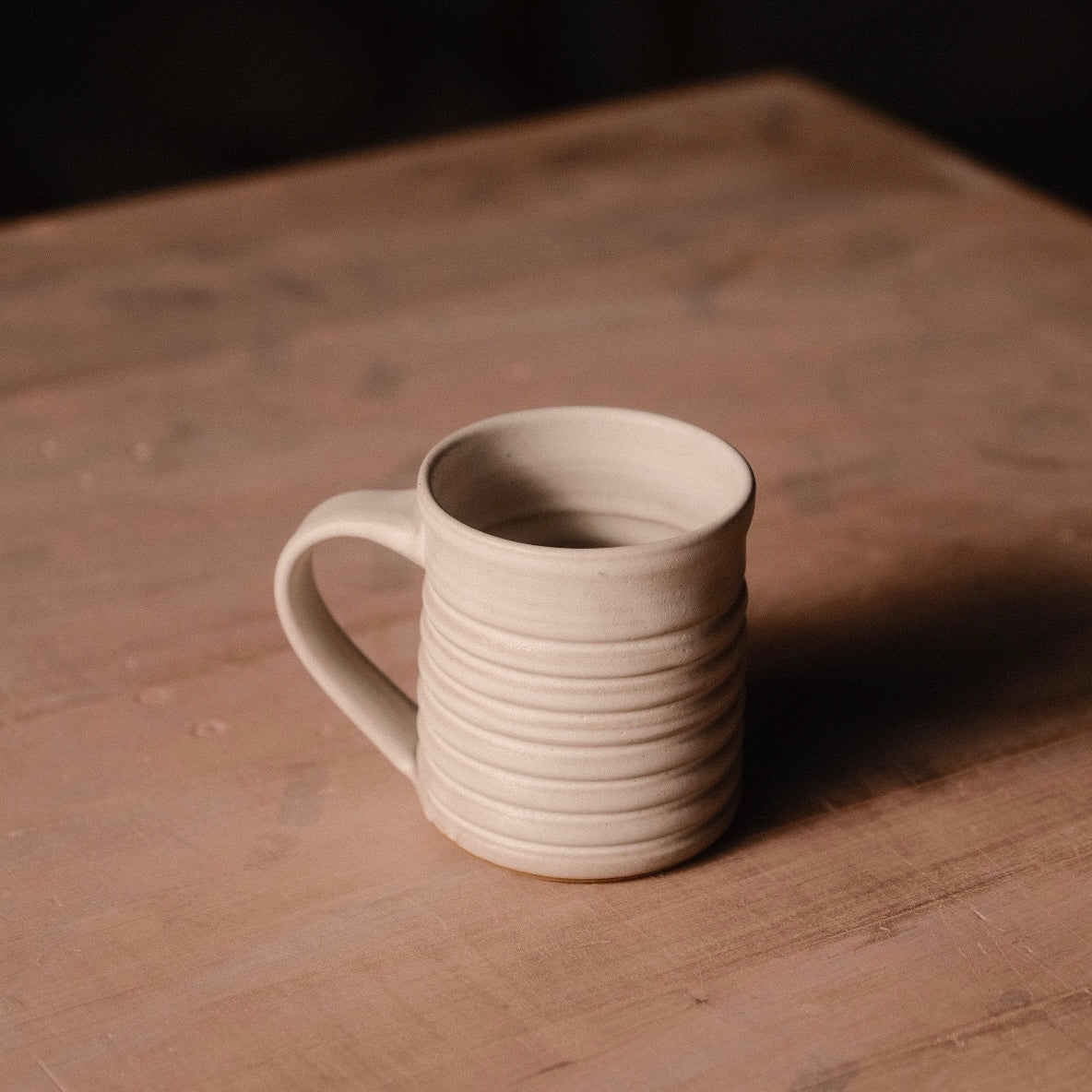 Hand-Thrown Stoneware Little Mug photographed on a bone white surface in soft natural light