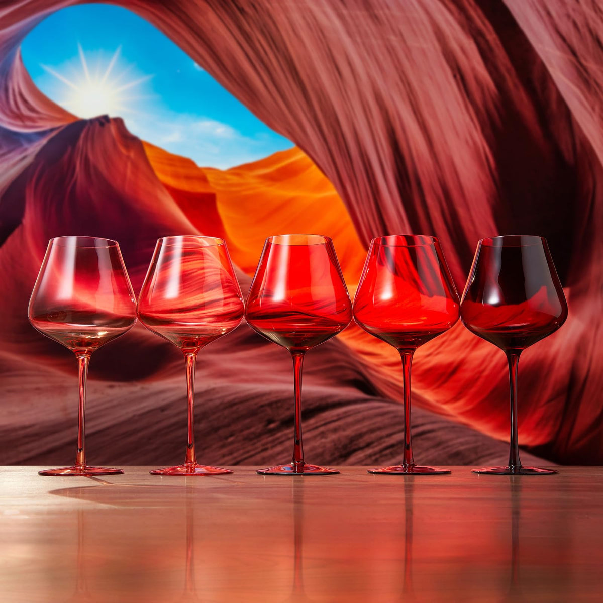 Red Rocks Gradient Wine Glassware shown beside companion pieces from the same maker's line