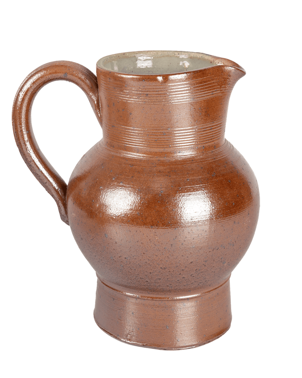 Front view of a speckled brown salt-glazed ceramic pitcher with a light interior on a green background