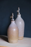 Tall Hand-Thrown Stoneware Oil Bottle shown beside companion pieces from the same maker's line