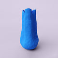 Tall Matte Blue Porcelain Vase photographed on a bone white surface in soft natural light