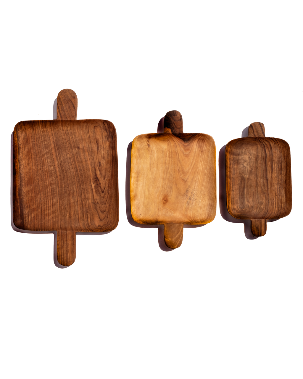 Small, medium and large walnut double handled trays lined up side by side on a black background