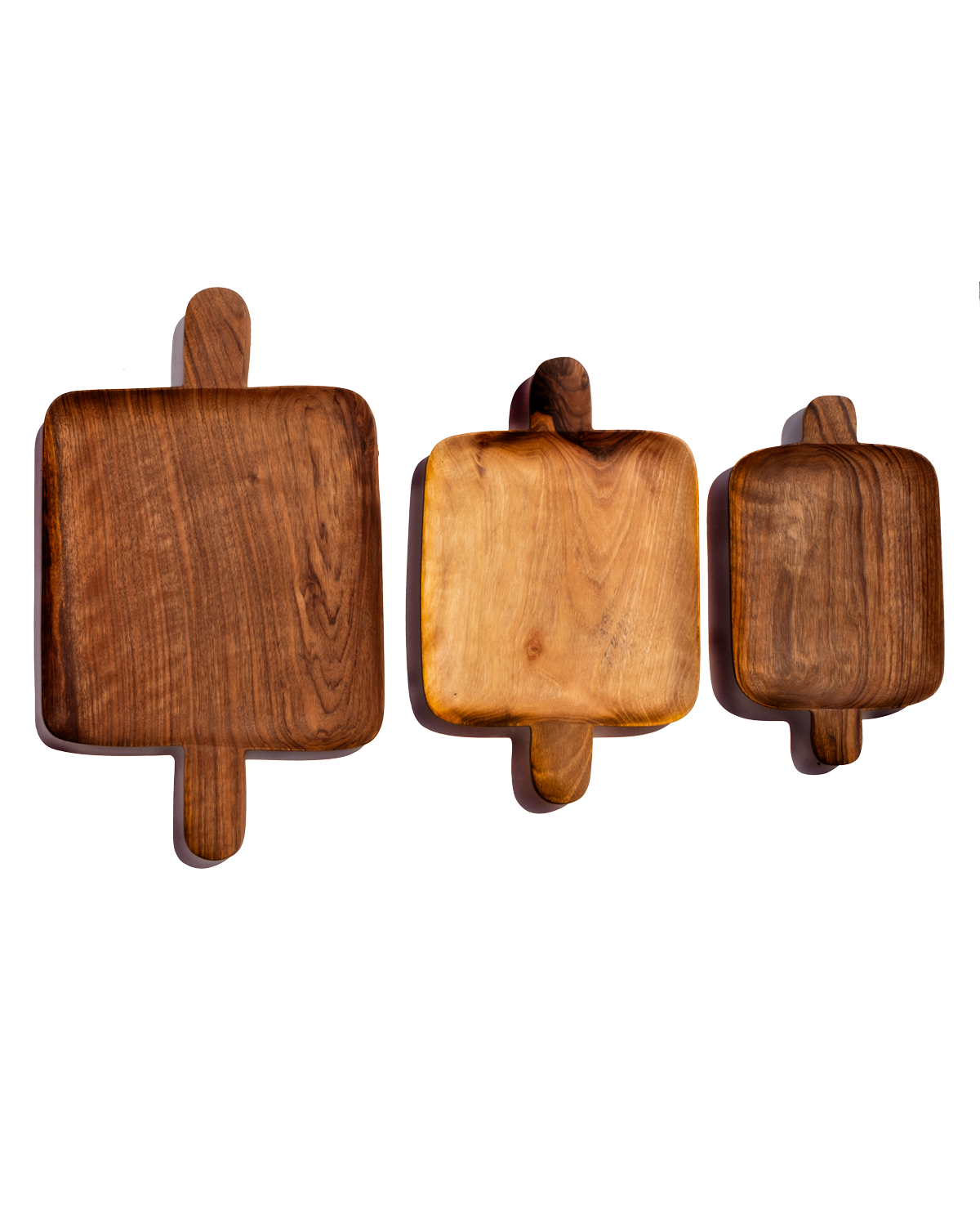 Small, medium and large walnut double handled trays lined up side by side on a black background