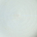 Close-up of a pale blue-white glaze with faint throwing rings on Texas stoneware, a swatch for the French butter keeper
