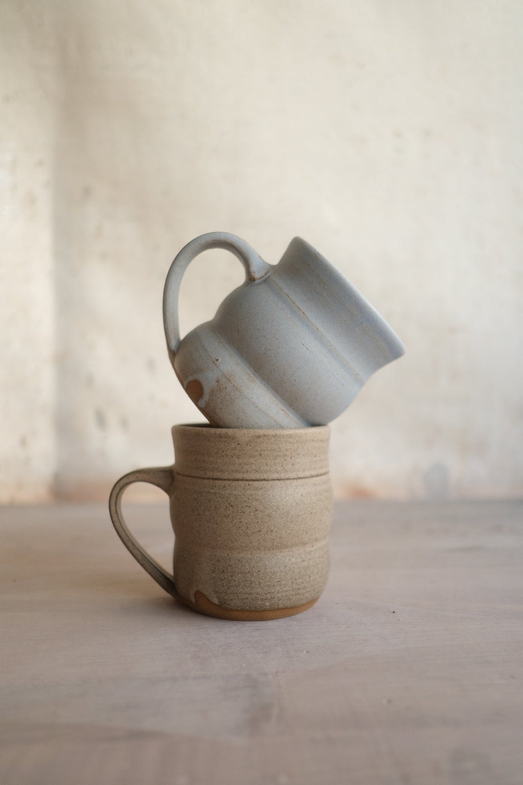 Hand-Thrown Stoneware Wave Mug styled on a wood table with linen in a modern Southwest room