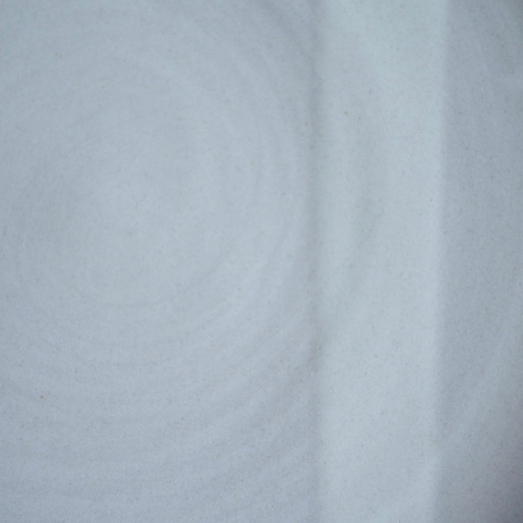 Close-up of a cool pale gray glaze with a soft satin finish on Texas stoneware, a swatch for the French butter keeper