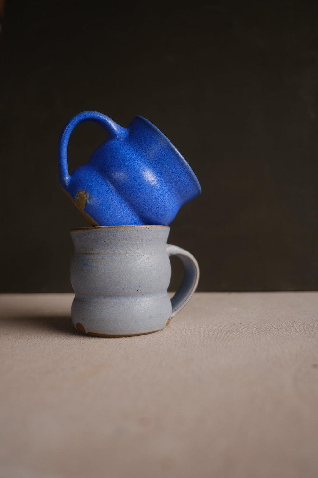 Hand-Thrown Stoneware Wave Mug shown from a second angle against a pale neutral backdrop
