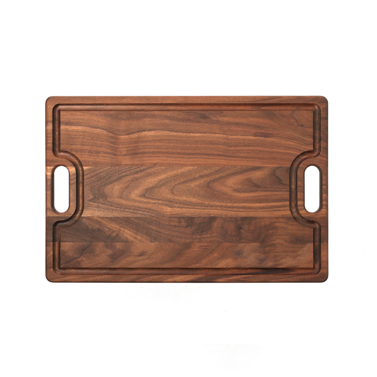 Walnut cutting board with cutout handles and a juice groove, 18 x 12 in, straight overhead view on white