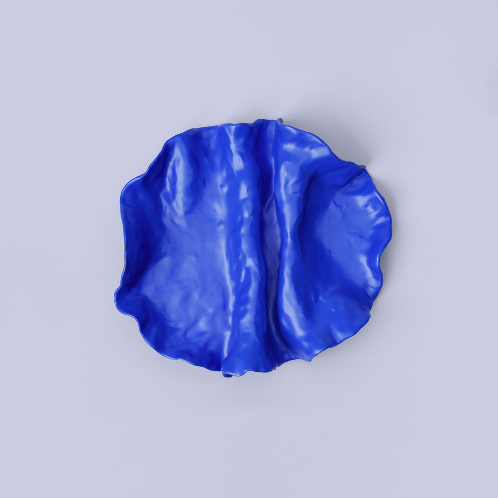 Folded Blue Porcelain Catchall Tray shown from a second angle against a pale neutral backdrop