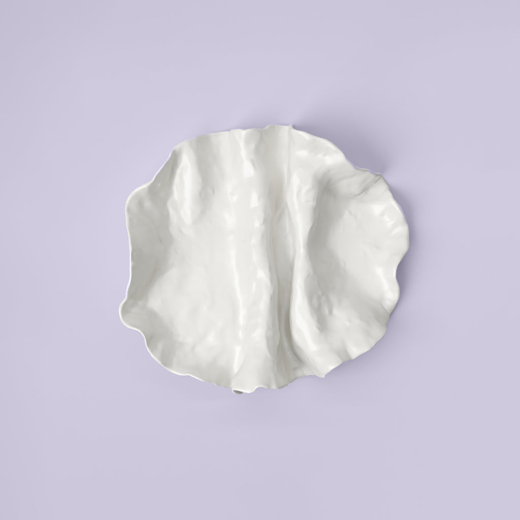 Folded White Porcelain Catchall Tray shown from a second angle against a pale neutral backdrop