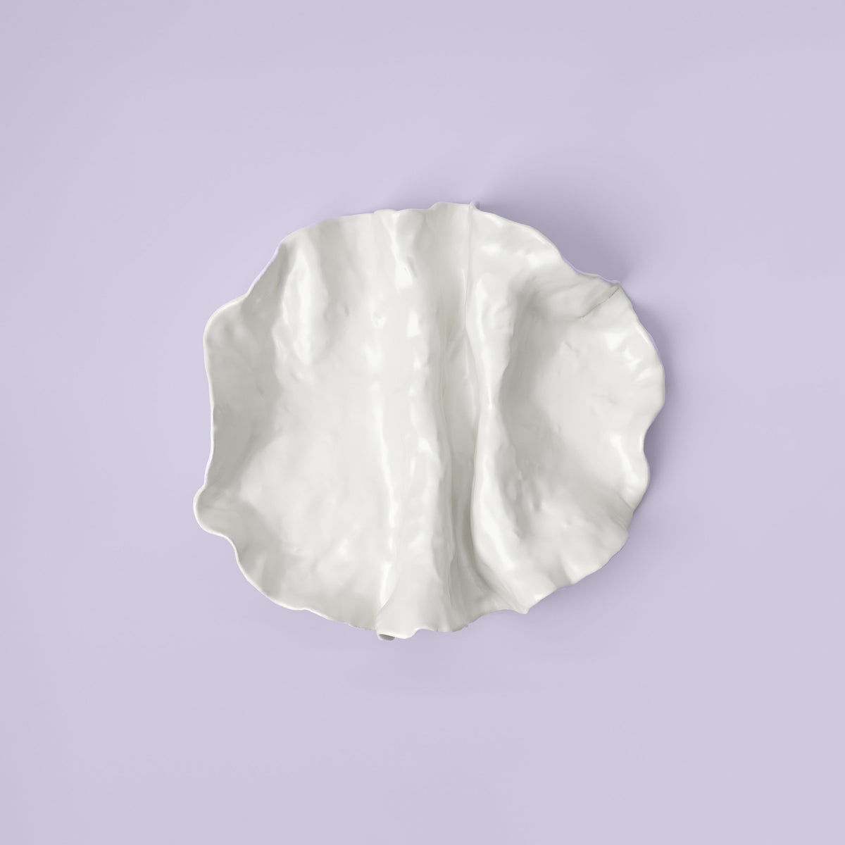 Folded White Porcelain Catchall Tray shown from a second angle against a pale neutral backdrop