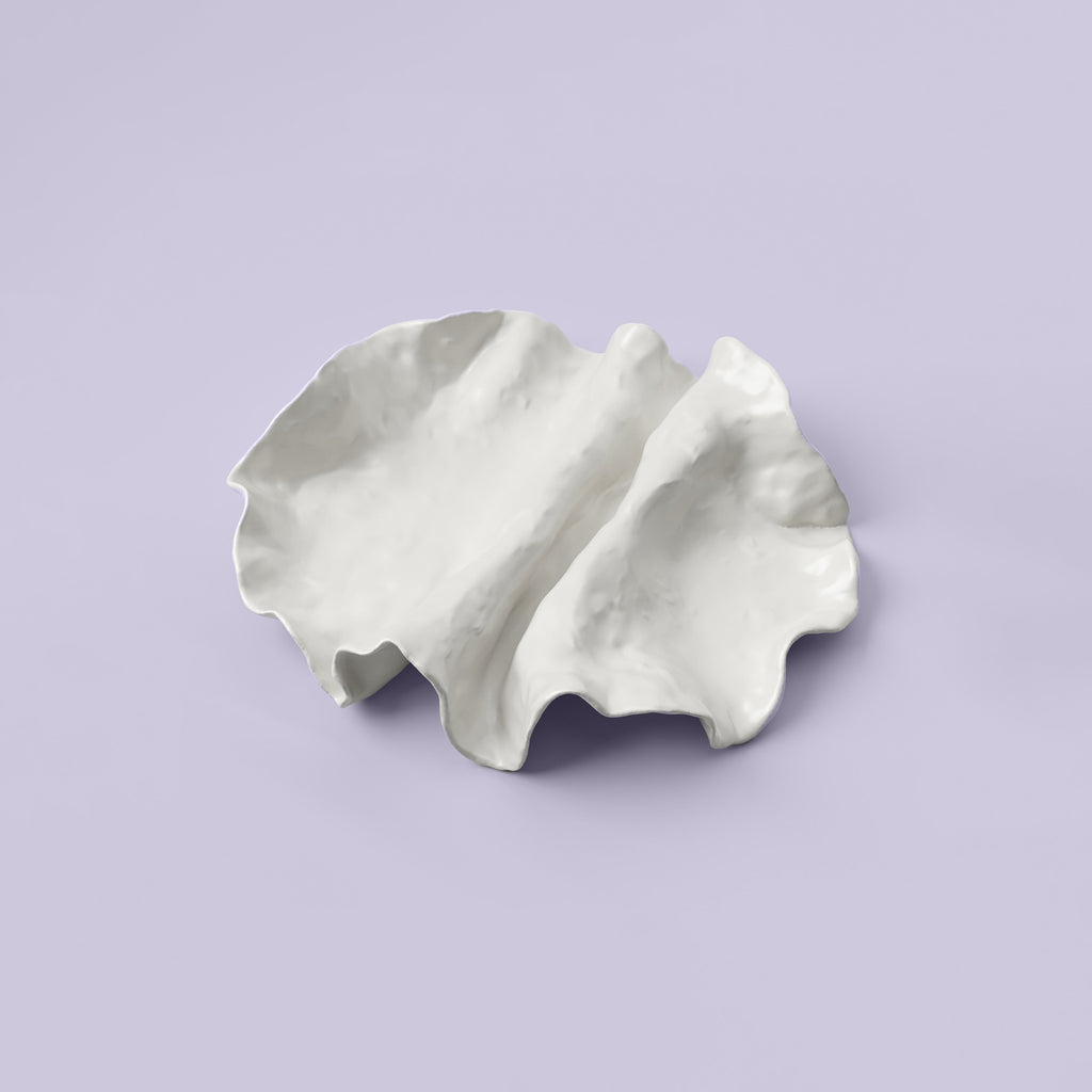Folded White Porcelain Catchall Tray photographed on a bone white surface in soft natural light