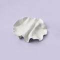 Folded White Porcelain Catchall Tray photographed on a bone white surface in soft natural light