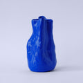 Sculpted Cobalt Blue Porcelain Vase photographed on a bone white surface in soft natural light