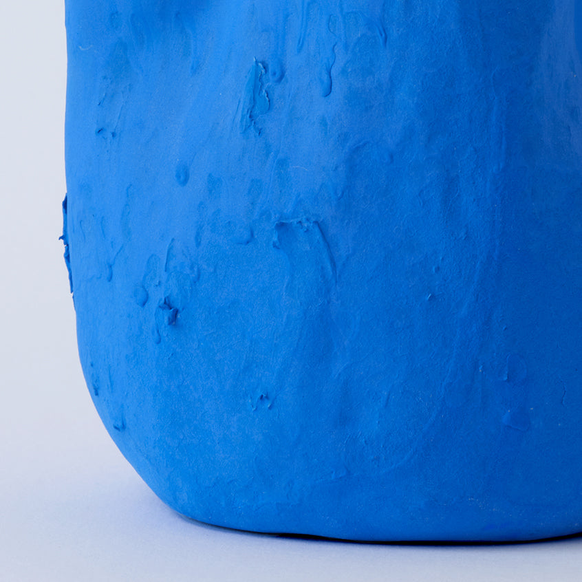 Sculpted Matte Blue Porcelain Vase styled on a wood table with linen in a modern Southwest room