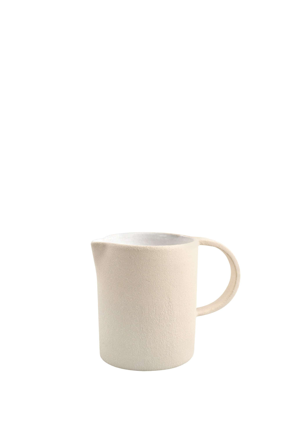 Raw stoneware pitcher shown in profile against a plain white background with its handle to the right