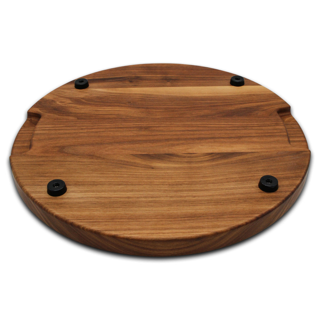 Thick round walnut cutting board, 18 in, angled view of the underside with pocket handles and rubber feet