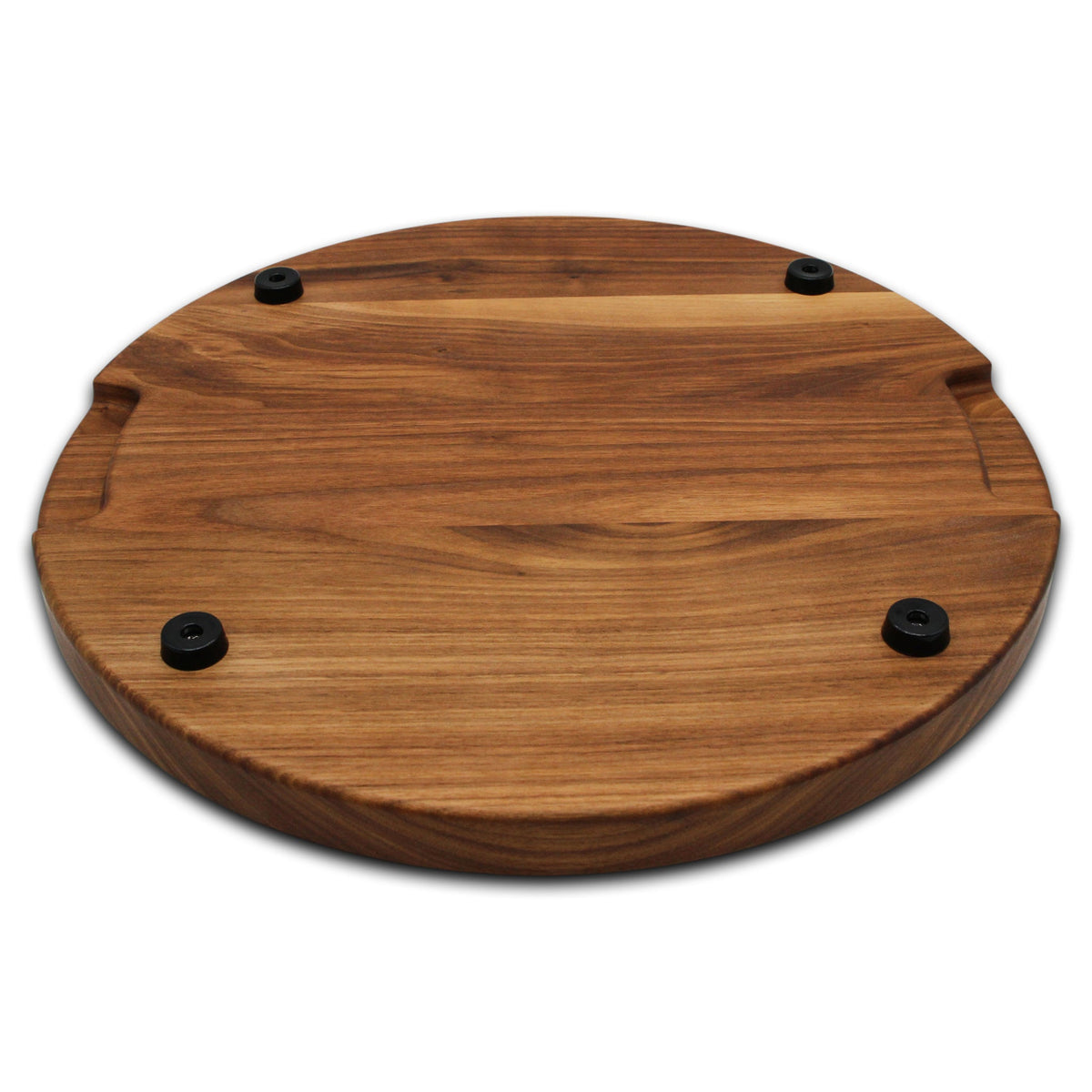 Thick round walnut cutting board, 18 in, angled view of the underside with pocket handles and rubber feet