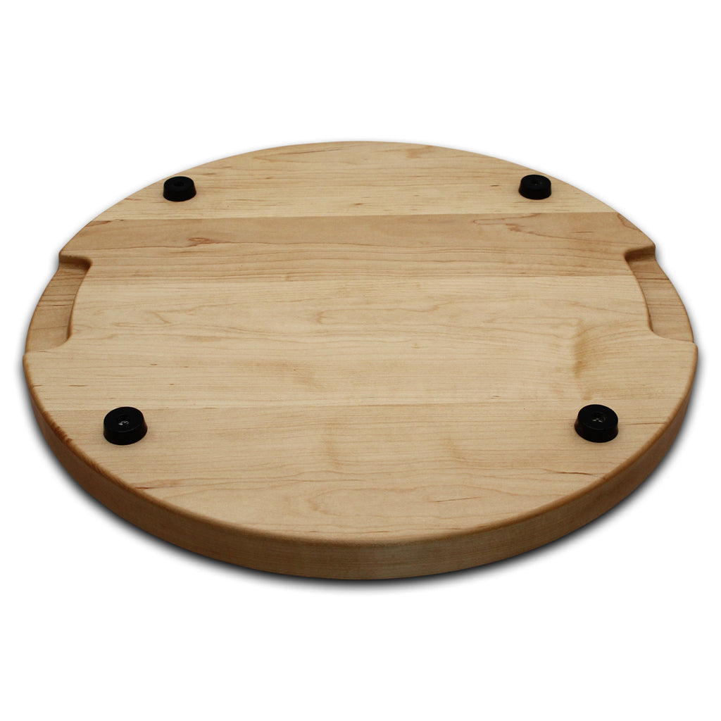 Thick round maple cutting board, 18 in, angled view of the underside with pocket handles and rubber feet