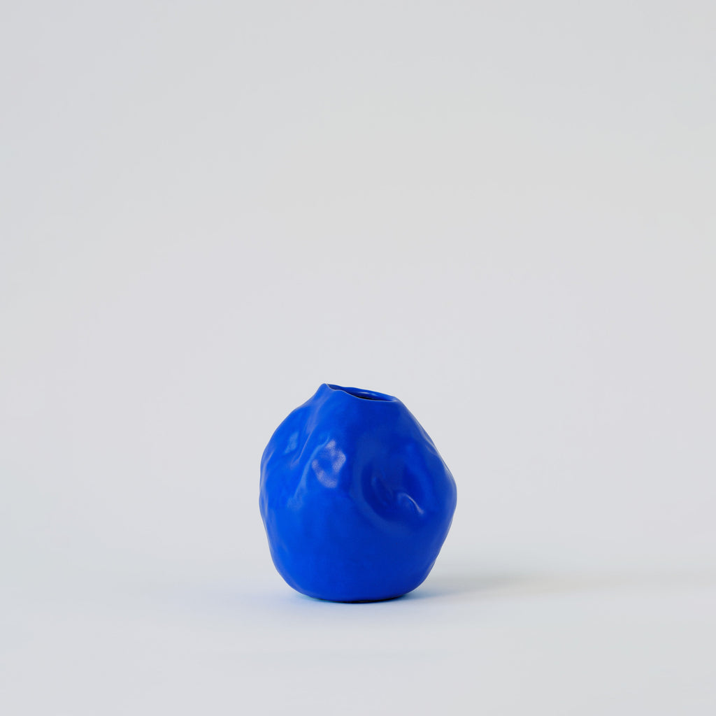 Cobalt Blue Porcelain Bud Vase styled on a wood table with linen in a modern Southwest room
