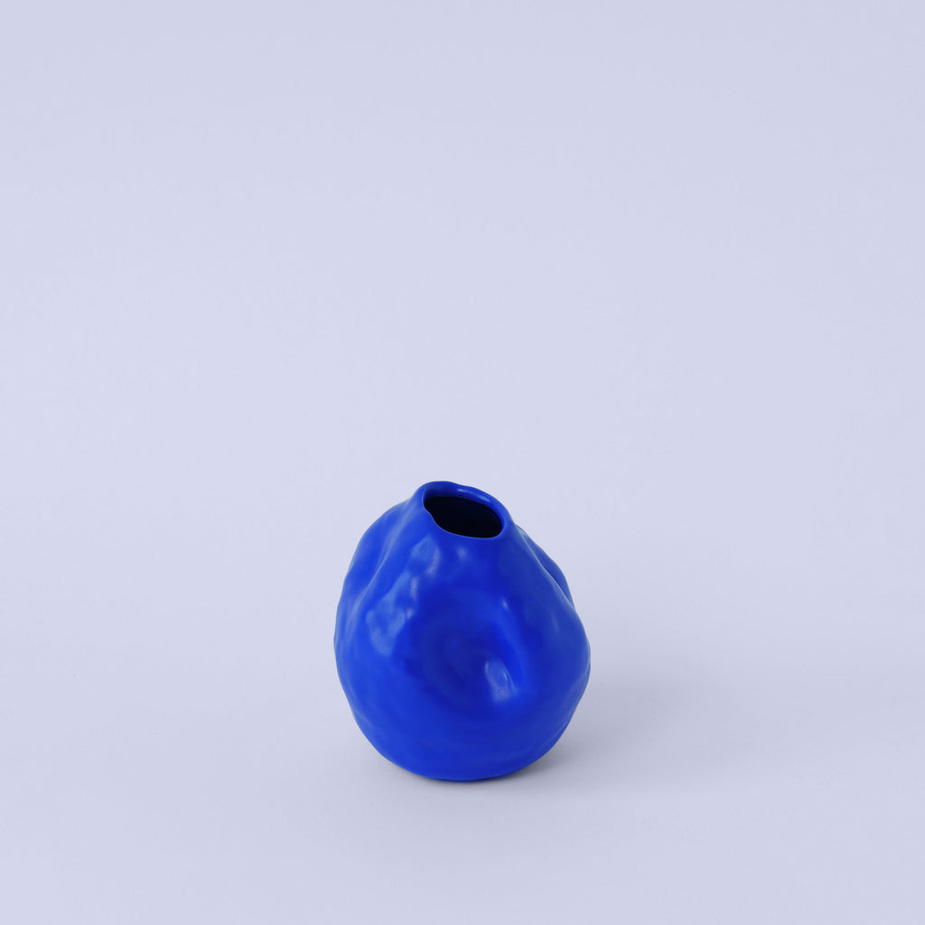 Cobalt Blue Porcelain Bud Vase photographed on a bone white surface in soft natural light