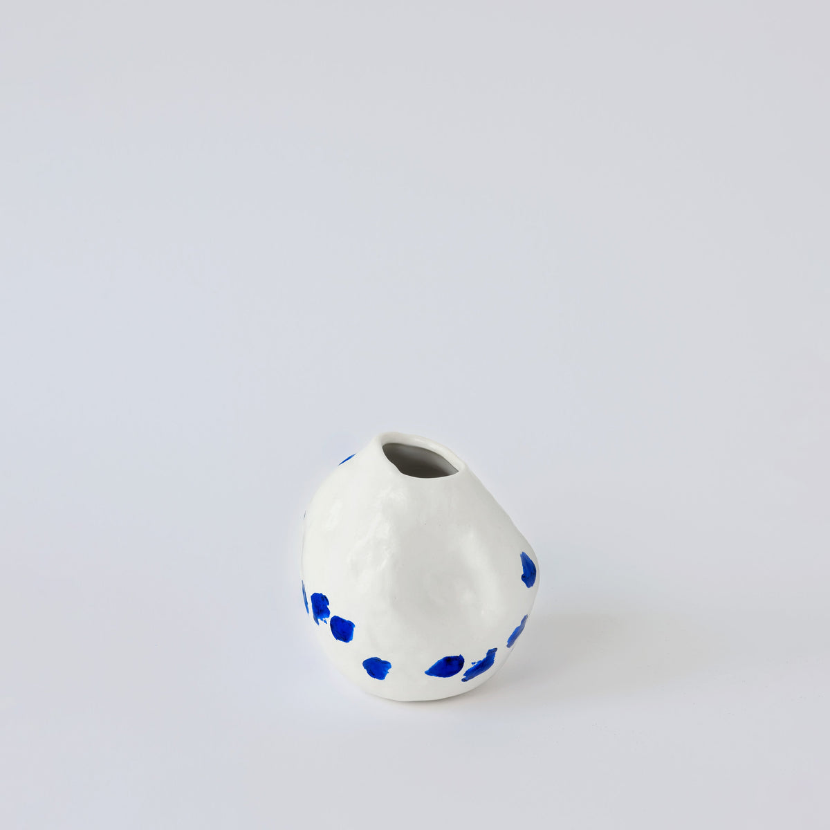 White and Blue Porcelain Bud Vase in a detail view showing surface texture and finish up close