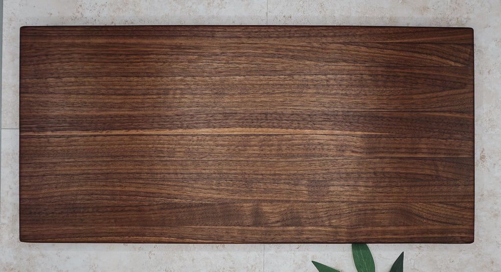 Large edge-grain walnut serving board shown flat from above to display its long grain stripes