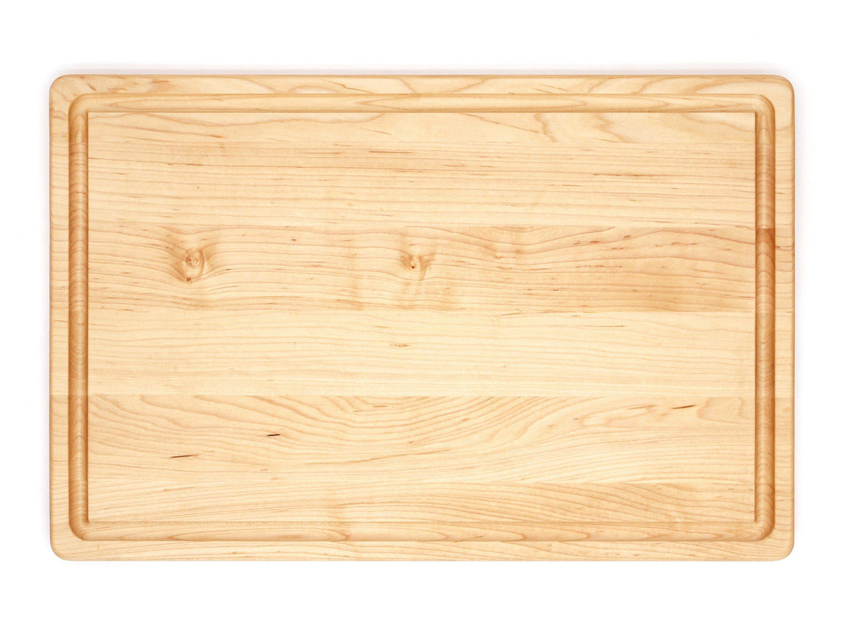 Maple cutting board with a juice groove, 18 x 12 in, straight overhead view on white