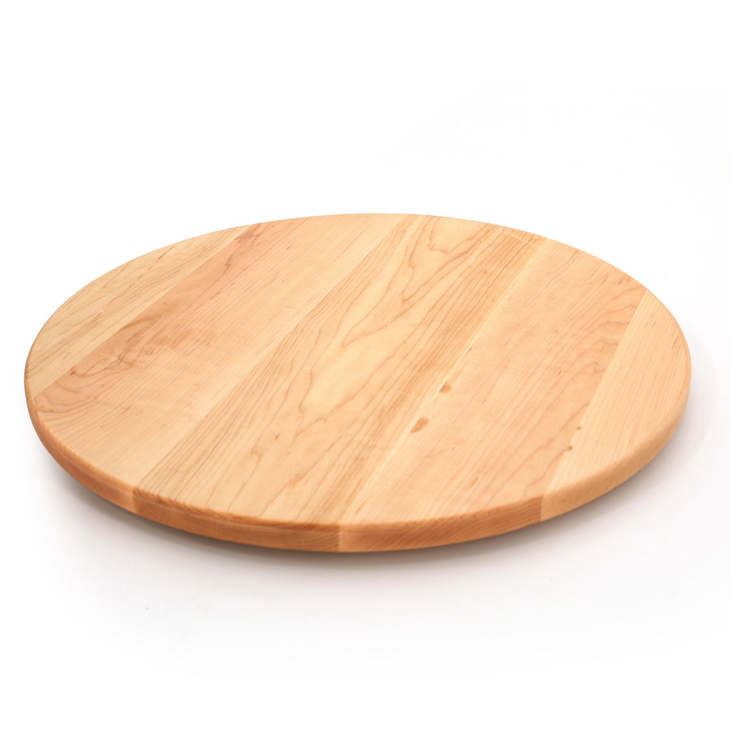 Round maple cutting board, 18 in, angled view on white showing warm grain and the rounded edge