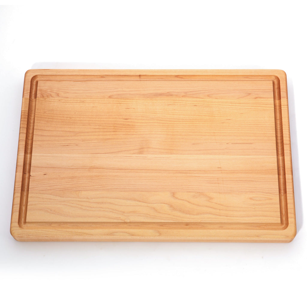 Thick maple cutting board with a juice groove, 20 x 15 in, straight overhead view on white