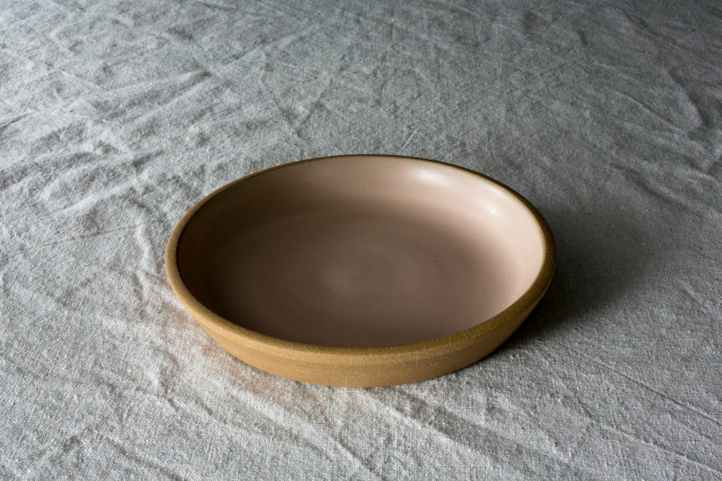Fat Rim stoneware lunch plate in a satin sand glaze with a thick raw clay rim on rumpled white linen