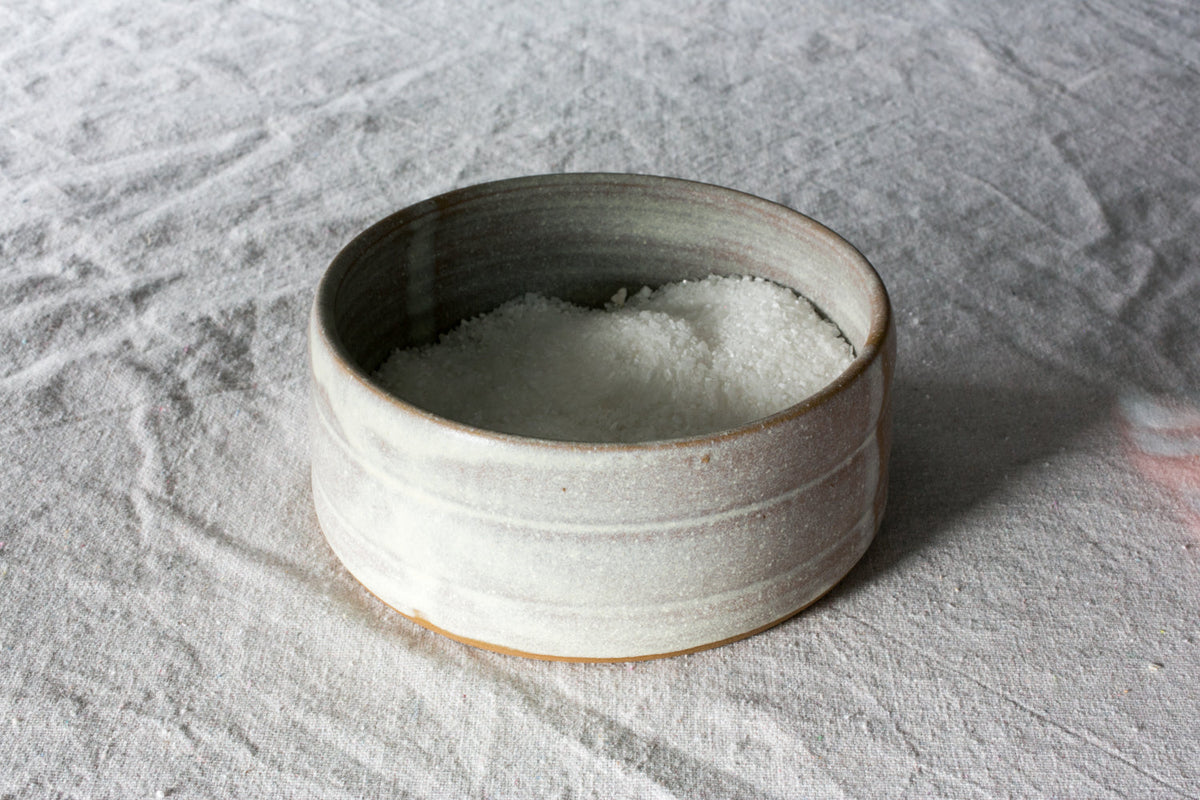 Open Hand-Thrown Stoneware Salt Pig photographed on a bone white surface in soft natural light