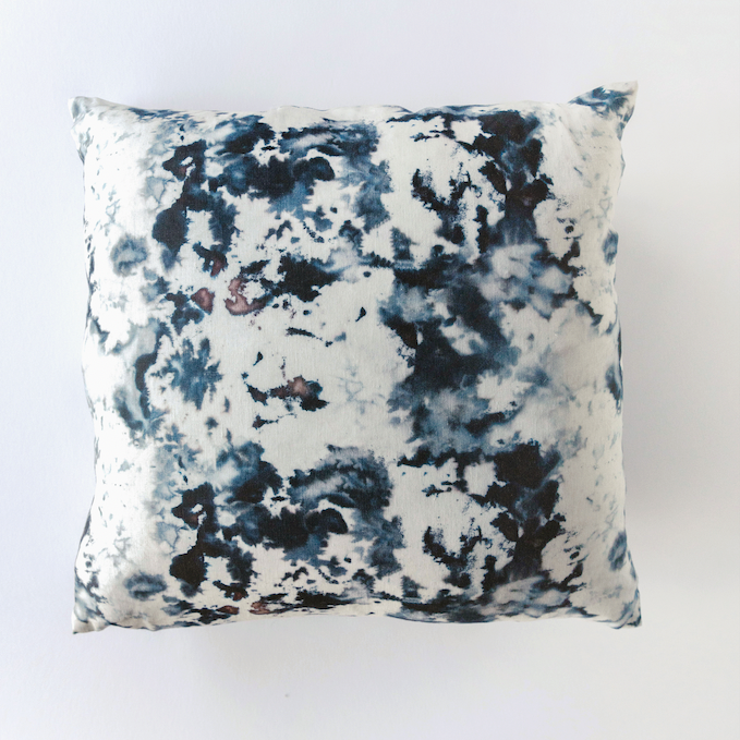 Hand-painted linen throw pillow in white with inky blue and black marbled blotches, square front view on white