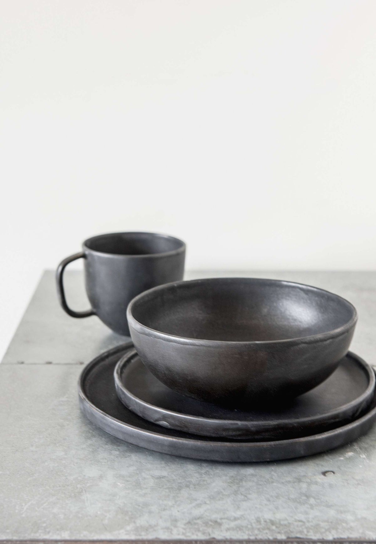 Matte Black Stoneware Mug styled on a wood table with linen in a modern Southwest room