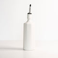 Porcelain Olive Oil Dispenser photographed on a bone white surface in soft natural light