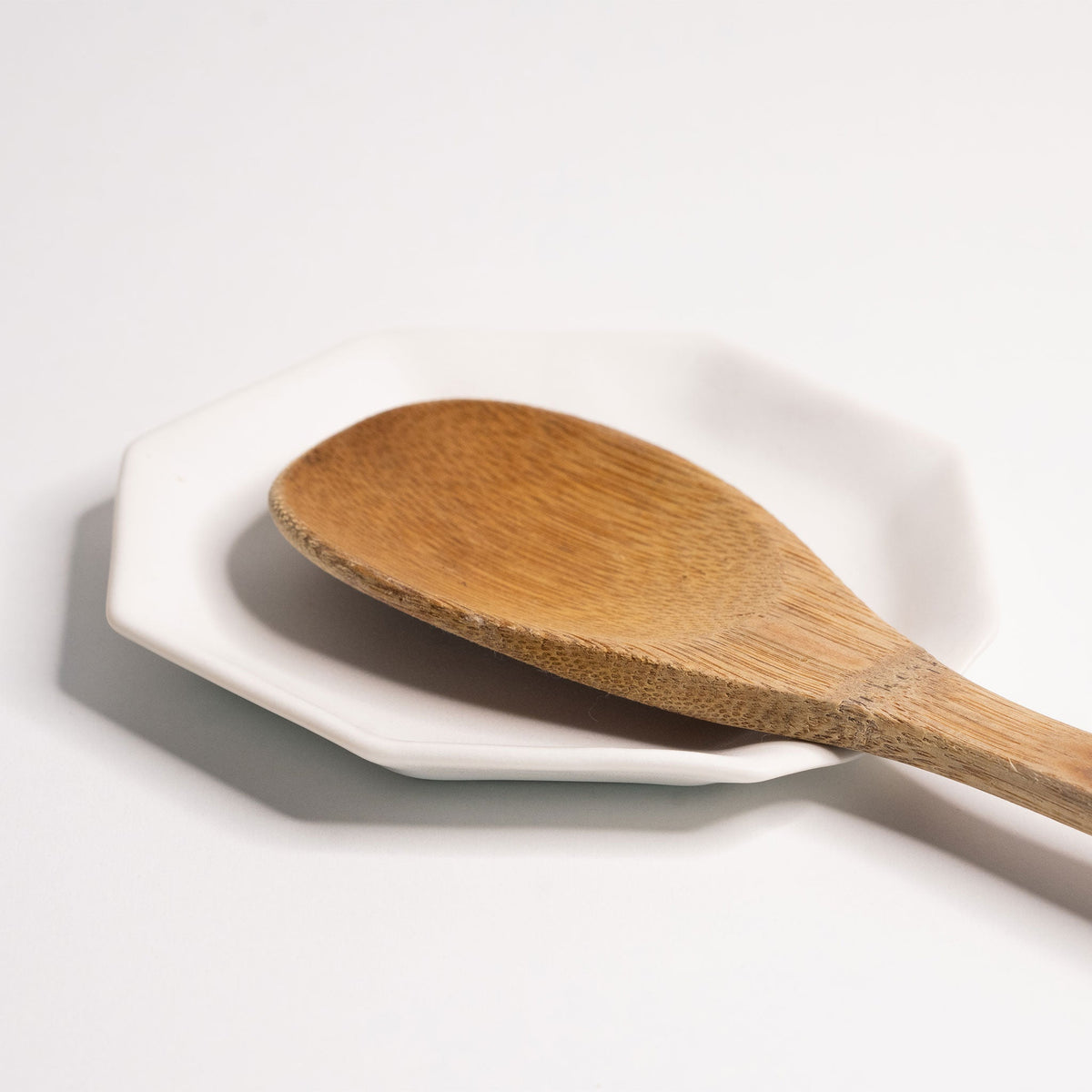 Octagonal Glazed Porcelain Spoon Rest shown from a second angle against a pale neutral backdrop