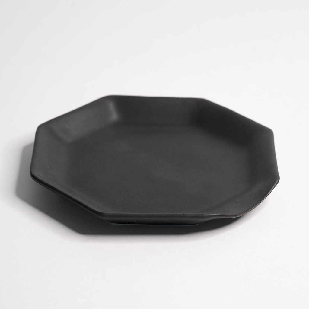 Octagonal Glazed Porcelain Spoon Rest placed on open kitchen shelving among neutral ceramics