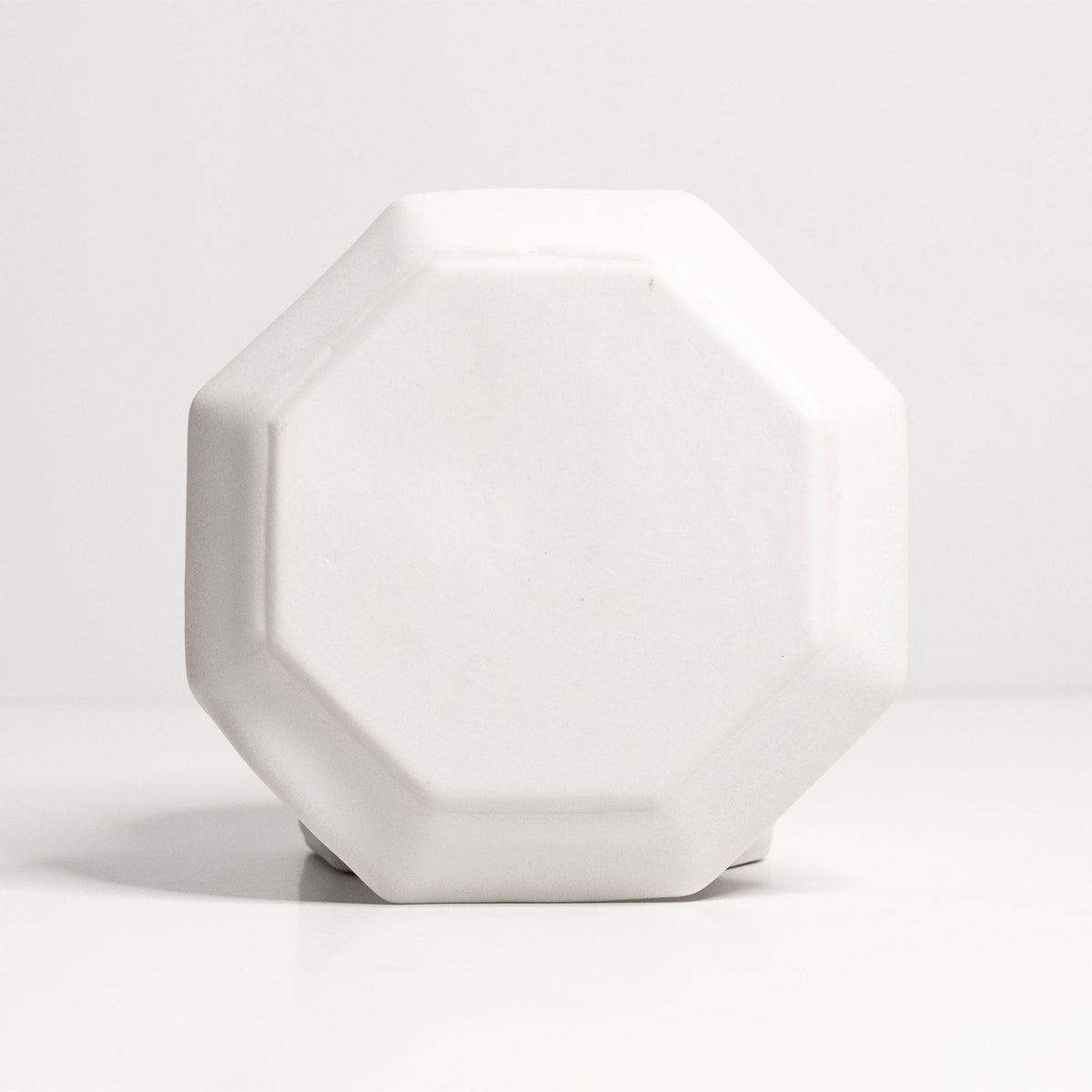 Octagonal Glazed Porcelain Spoon Rest shown in use on a casually set gathering table at dinner