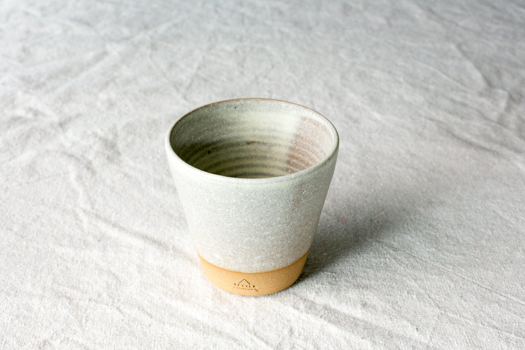 Short Hand-Thrown Stoneware Tumbler Cup photographed on a bone white surface in soft natural light