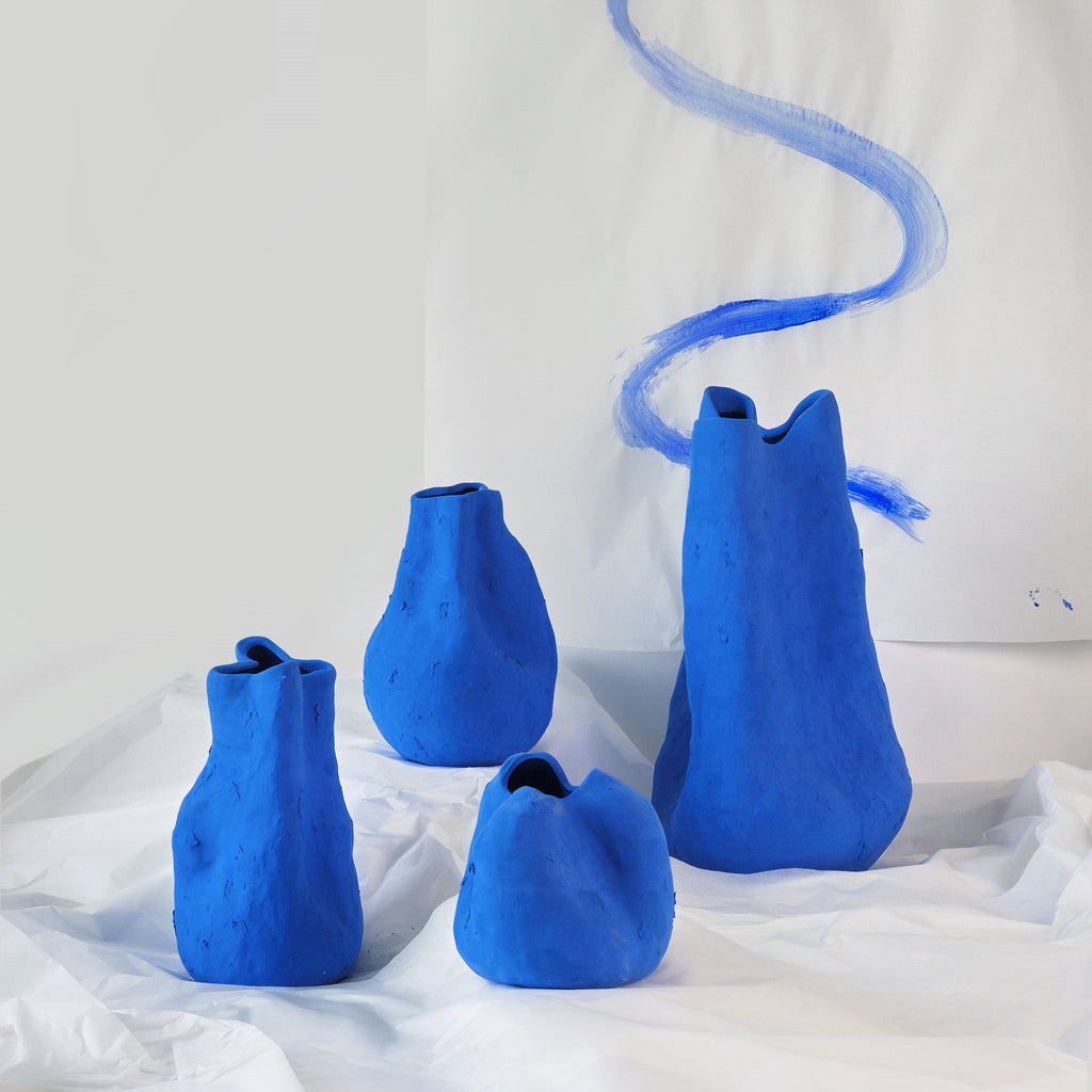 Tall Matte Blue Porcelain Vase shown from a second angle against a pale neutral backdrop
