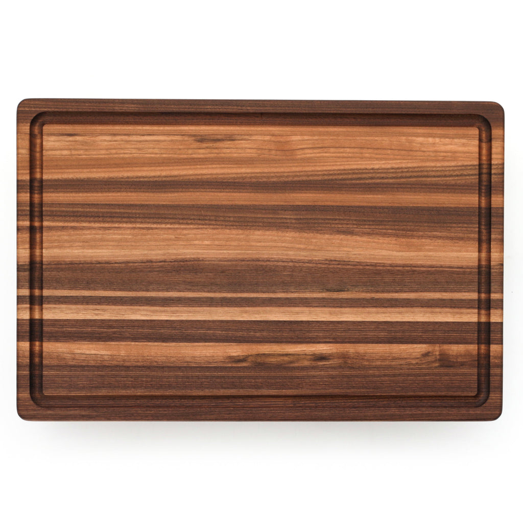 Edge grain walnut cutting board with a juice groove, 18 x 12 in, straight overhead view on white