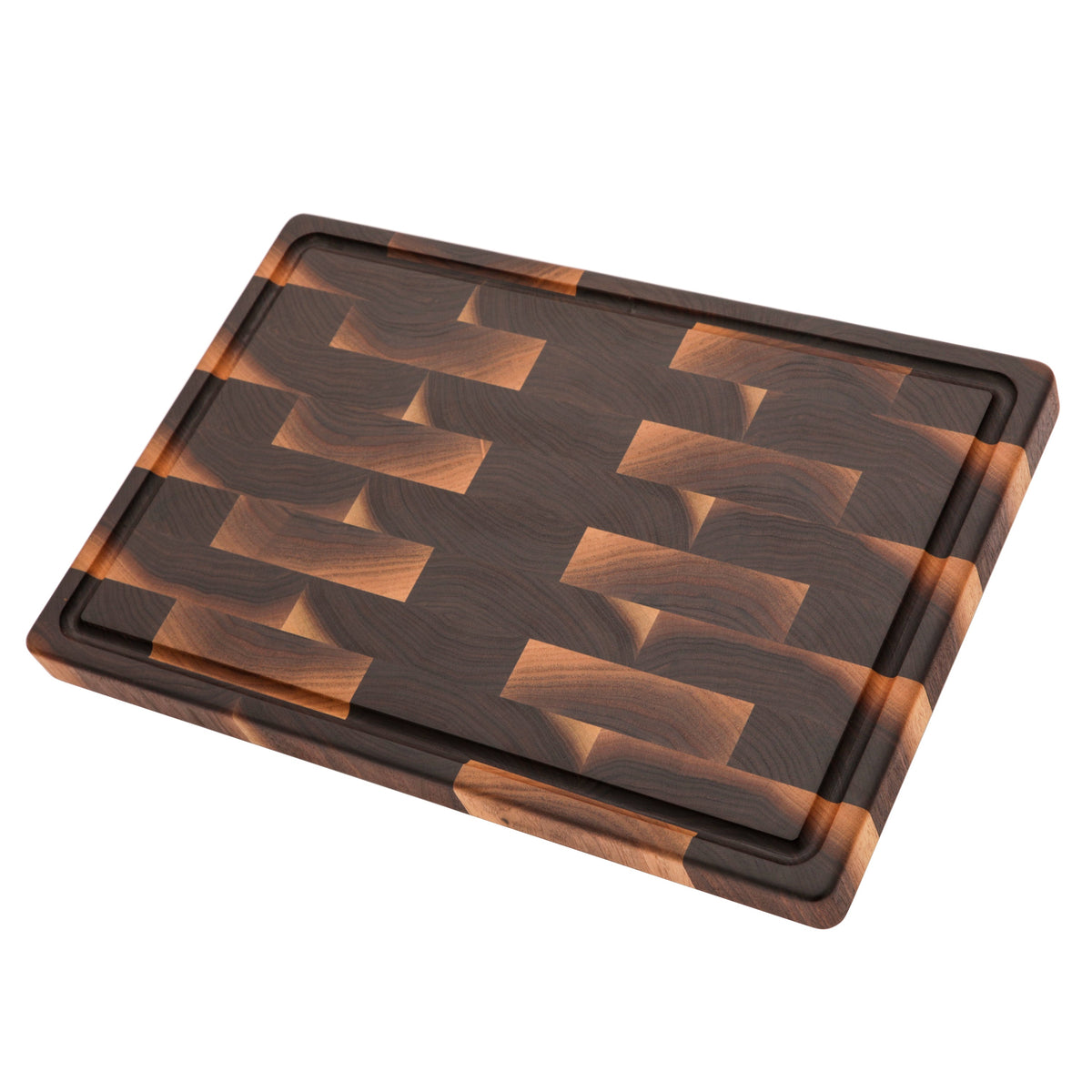 End grain walnut cutting board with a juice groove, 18 x 12 in, lying at an angle on white