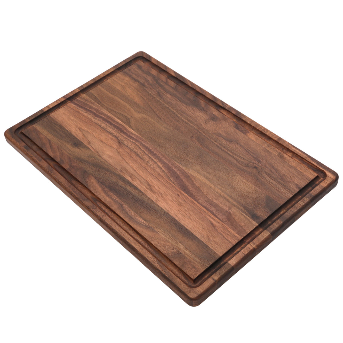 Walnut cutting board with a juice groove, 18 x 12 in, lying at an angle on white with warm striped grain